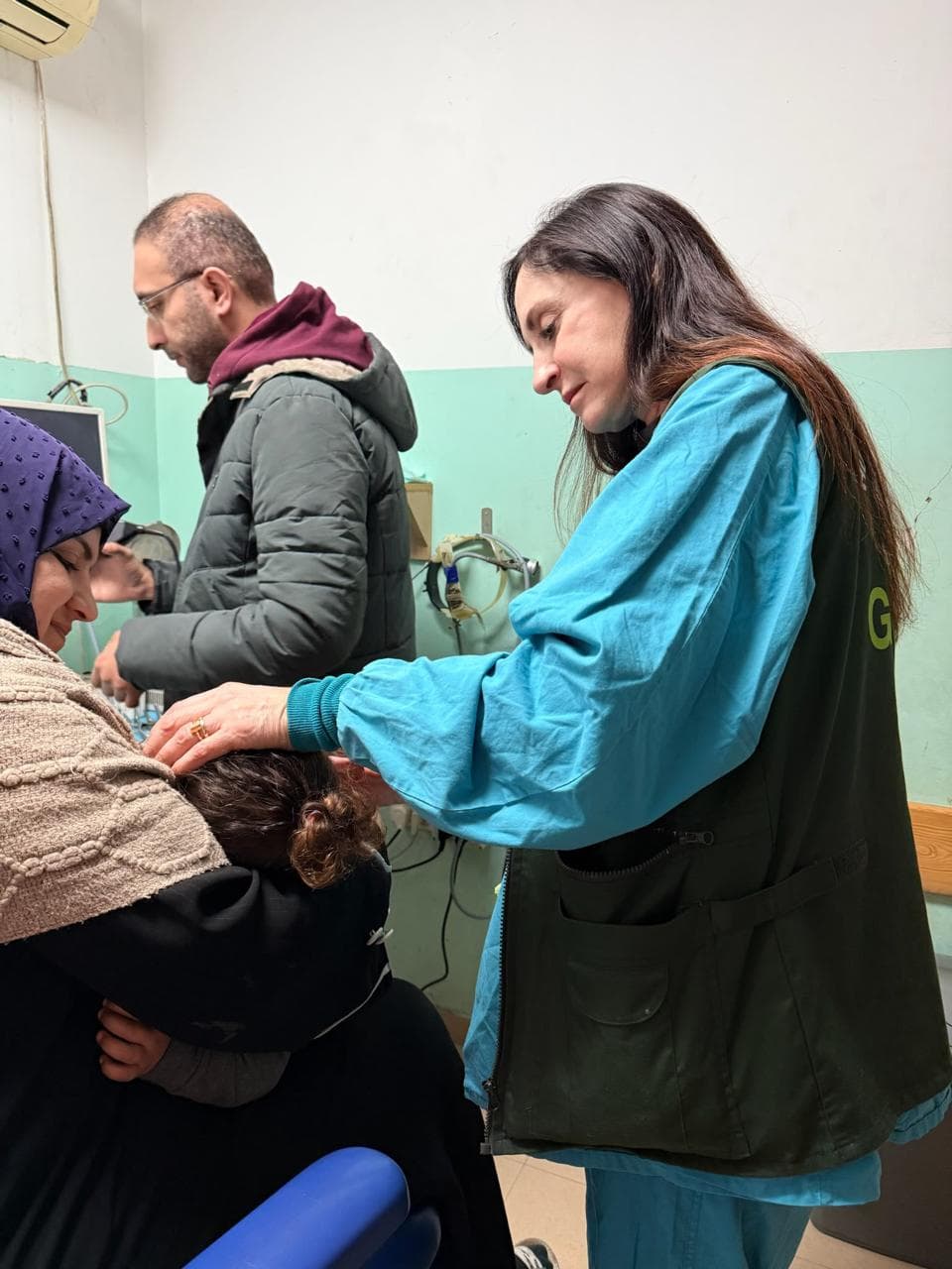 Volunteer doctor examining a patient's head