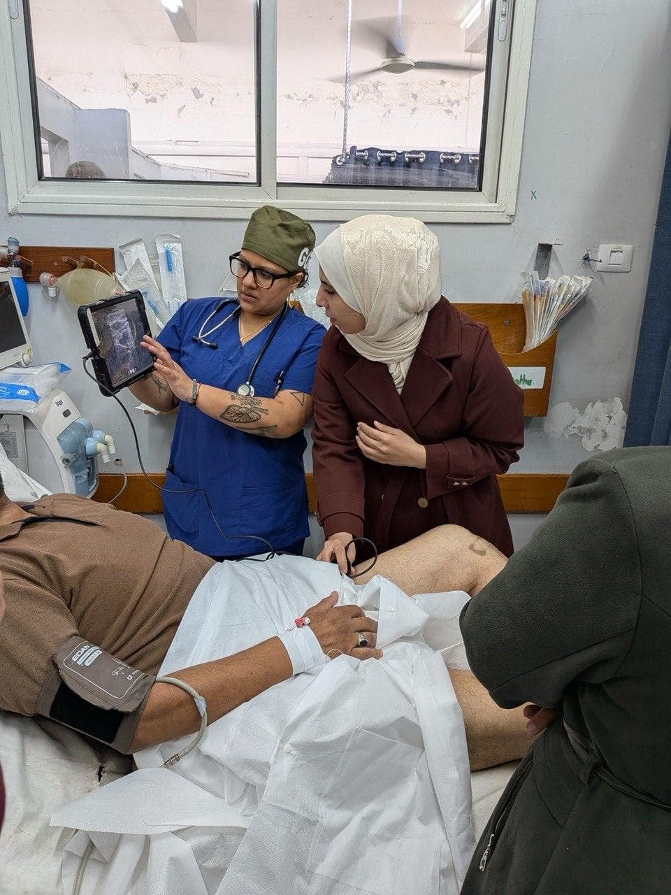 Doctor showing a patient's family an image on a tablet