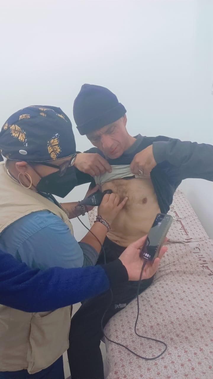 Volunteer performing an ultrasound scan on a patient