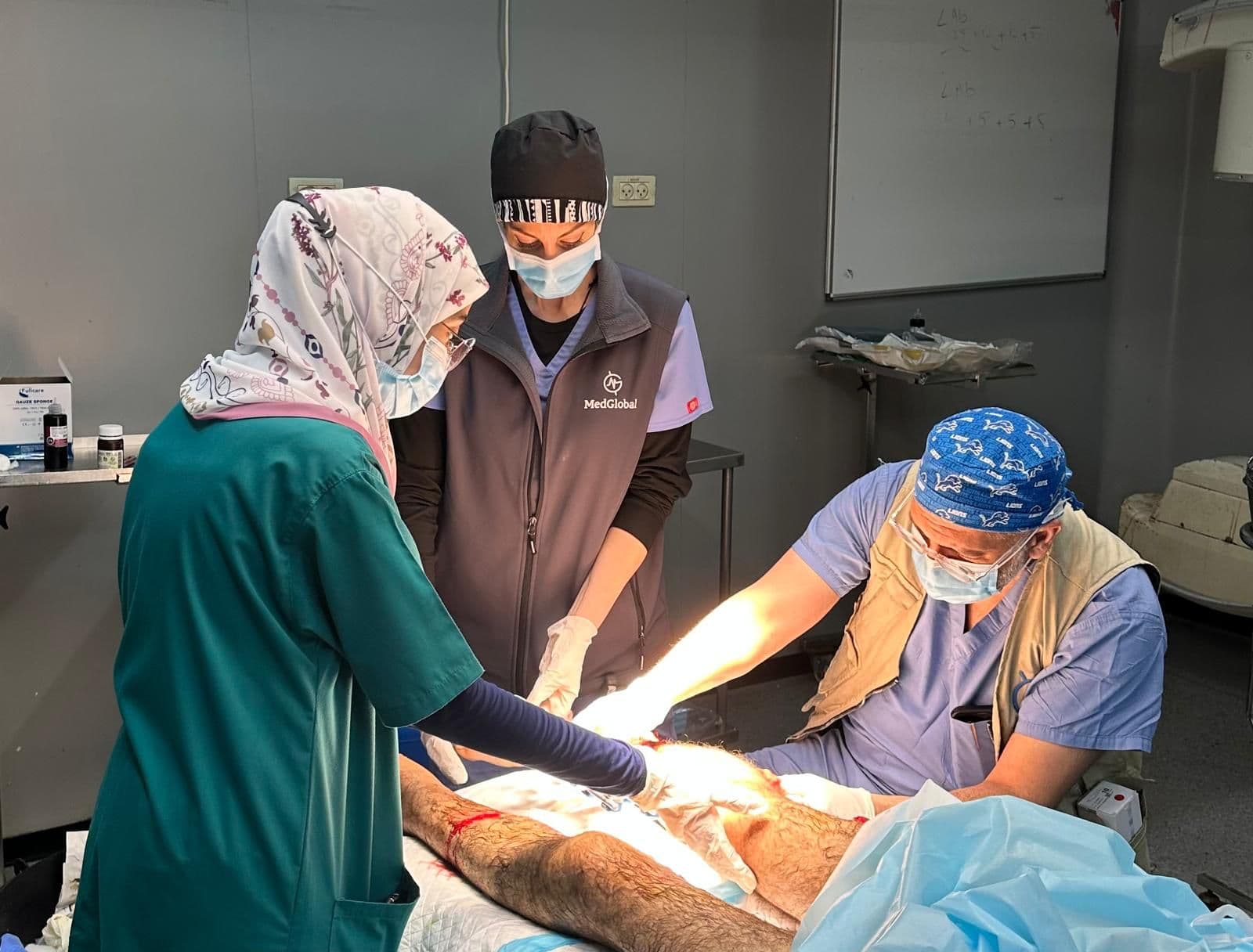 Surgical team operating on a patient's leg