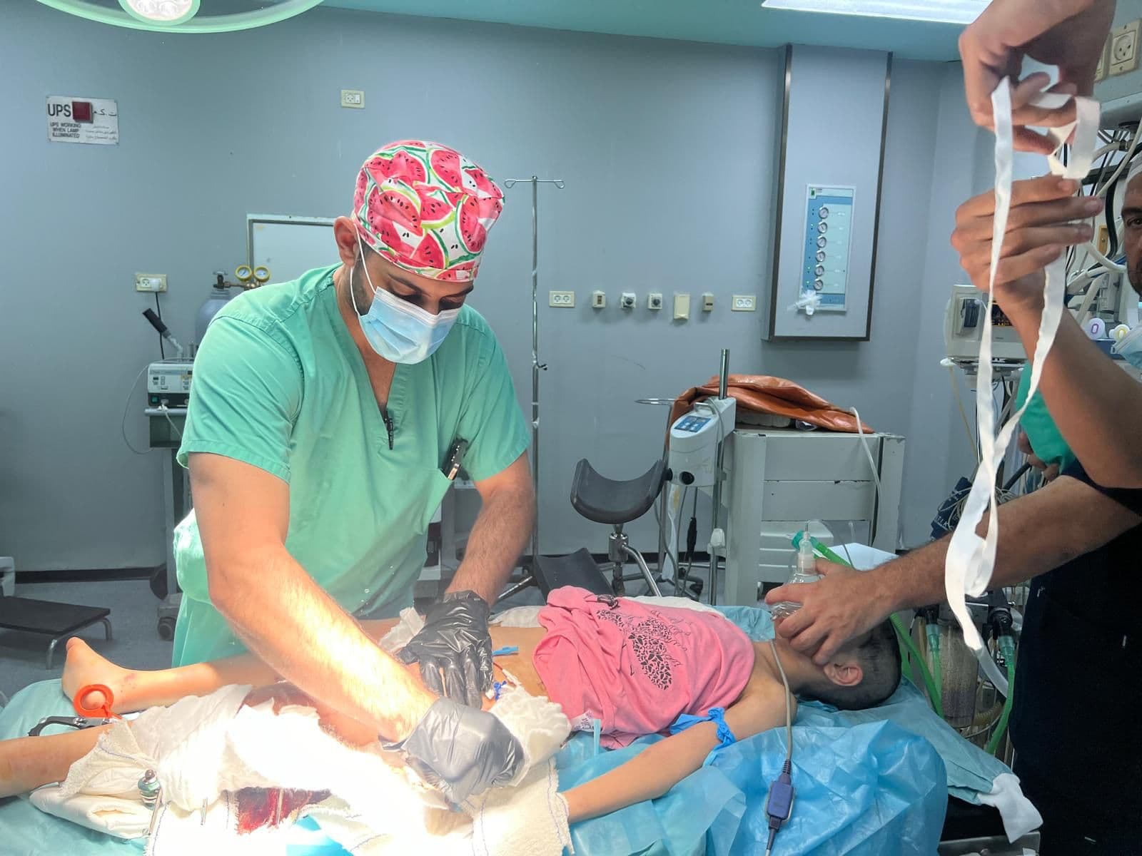 Surgeon operating on a young patient